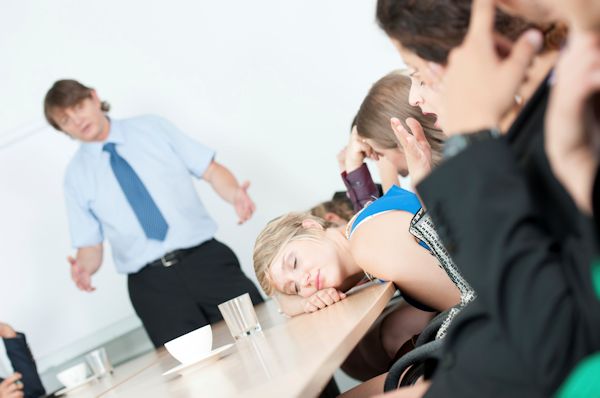 Image showing a bored tired student sitting with head on a table