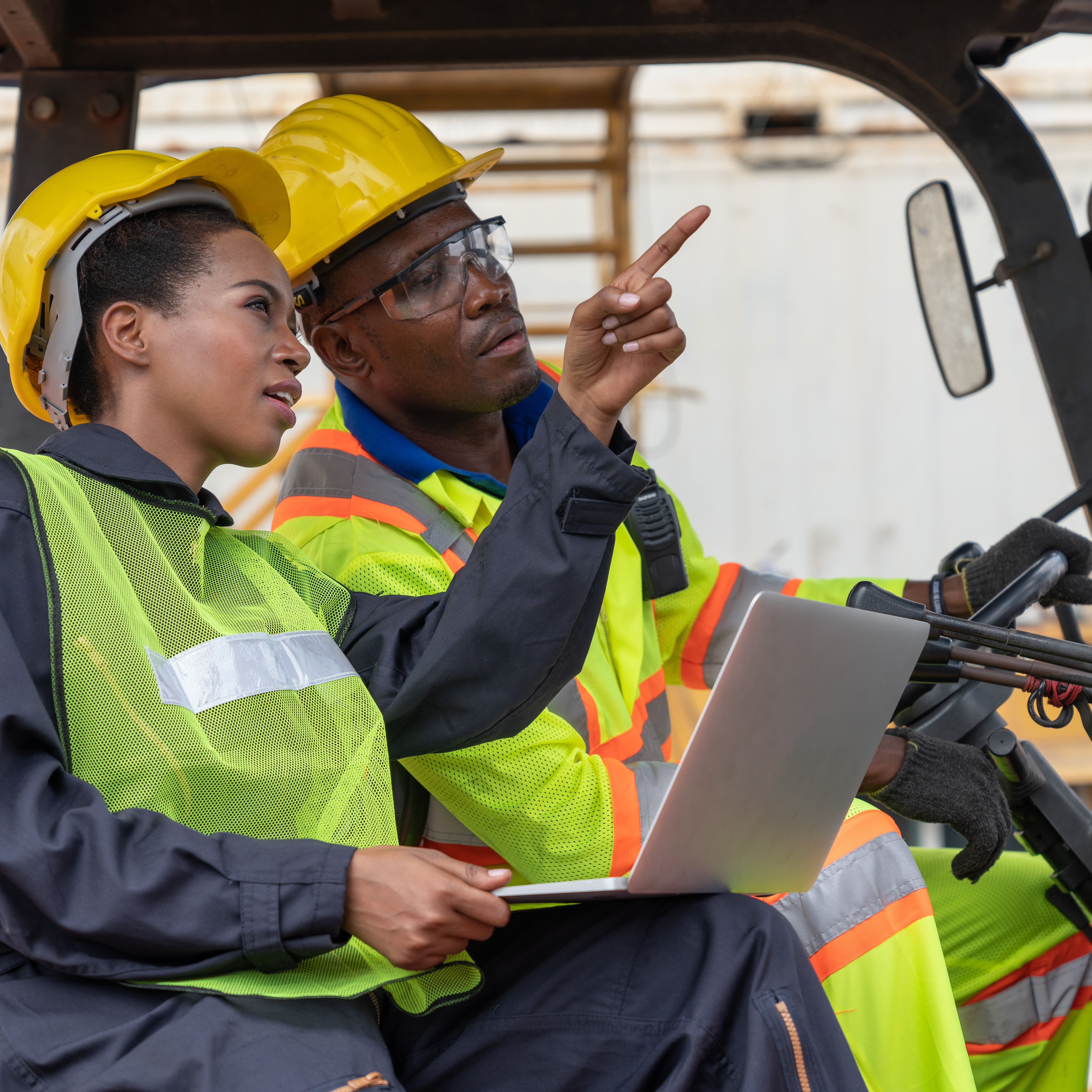 Supervisor evaluating forklift driver