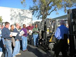 workers participating in a forklift training session.
