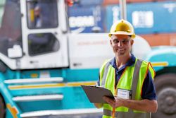 worker inspecting a forklift