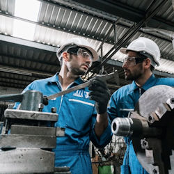 Image showing two workers working with a lathe