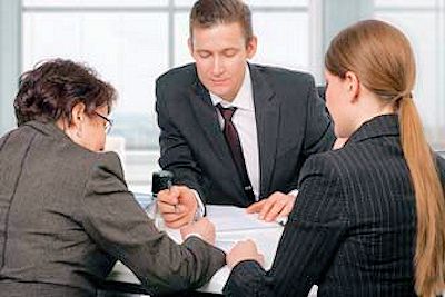 A three member planning team checking processes.