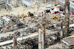 Overhead view of oil refinery explosion resulting in massive destruction.