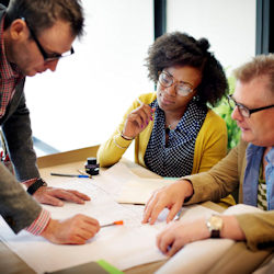Image of three-person team in a planning session.