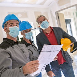 Three contractors discussing renovation