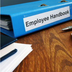Notebook labled employee handbook