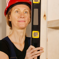 Image of worker holding a level.