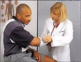 doctor wrapping arm of patient.