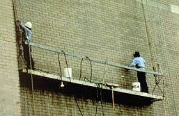 Two workers on suspended scaffold.