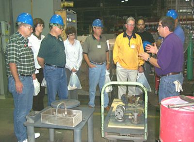 A group of workers involved in an on-the-job training session.