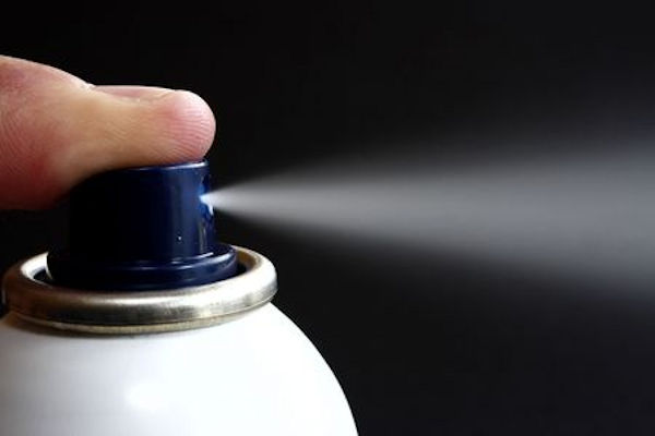 spray can spreading aerosol mist