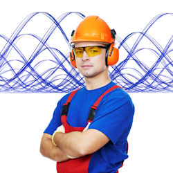 employee with folded arms wearing hard hat and ear protection