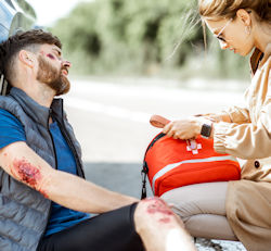 employee administering first aid to injured worker