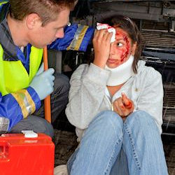 worker covering injured eye and co-worker providing first aid