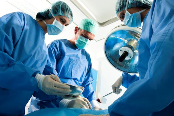 Surgeon and nurses in operation room with patient