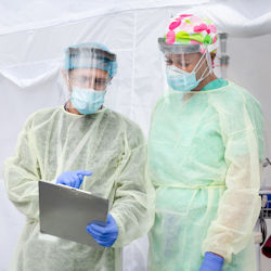 healthcare employees wearing ppe to comply with universal precautions