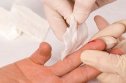 gloved hand helping person with bloody finger