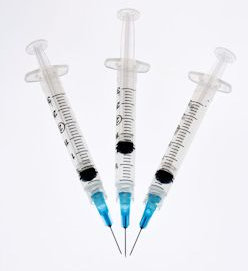three vaccination needles ready to use