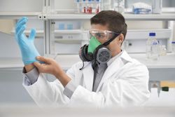 Lab worker with eye and face and hand protection