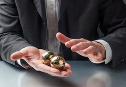 Image of man holding steel stress balls in his hands.