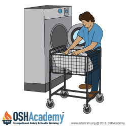 Image of worker loading a washer.