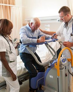 Image of moving workers moving a patient out of bed