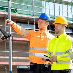 Two workers inspecting a scaffold after installation and prior to use