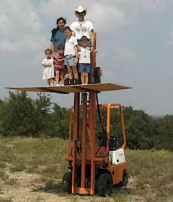 Staged funny picture of family posing together on an elevated board