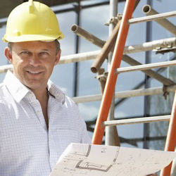 Worker standing near straight ladder