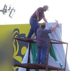 Two men covering a board with risky unsafe support