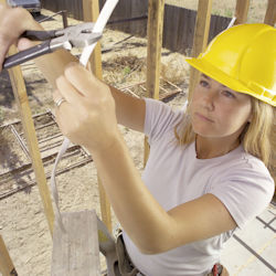 Worker cutting a wire