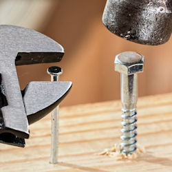 Wrench turning a nail and hammer pounding a screw.