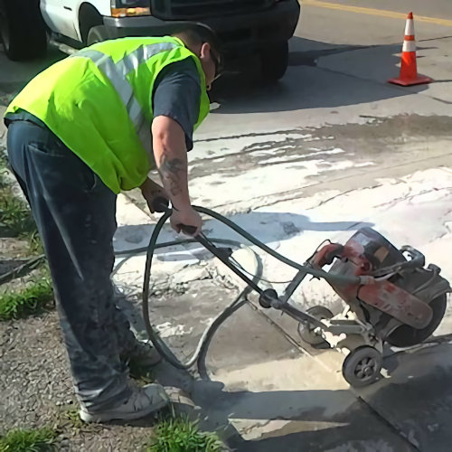 Worker cutting cement