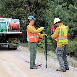 Traffic workzone workers in bright orange and yellow safety vests