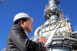 Contractor with notepad standing in front of worksite