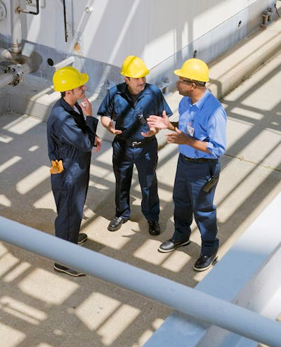 Overhead view of three workers in a discussion
