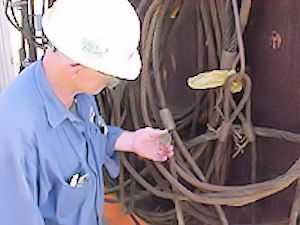 Worker inspecting lines and slings