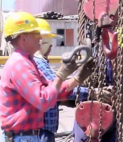 Workers inspecting shackles