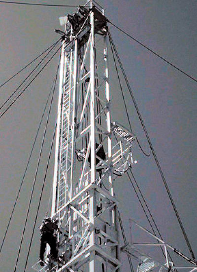 Worker climbing tower ladder