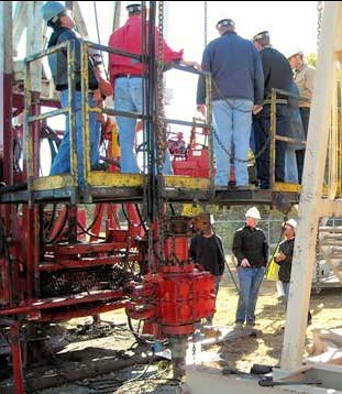 Several employees standing on a work platform