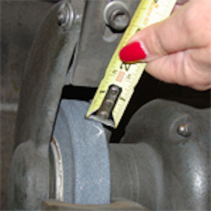 Employee using a tape measure to check required clearances