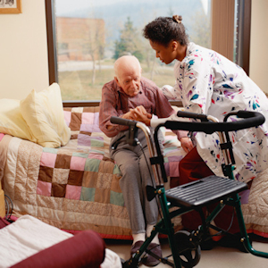 Image of nurse assisting and elderly man