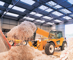 Image of recycling center and a powered industrial truck picking up shredded cardboard