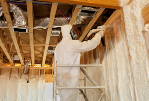 Image of employees spraying insulation in a building